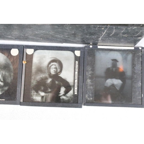 601 - A collection of over 100 magic lantern slides contained within three wooden boxes, mainly people to ... 