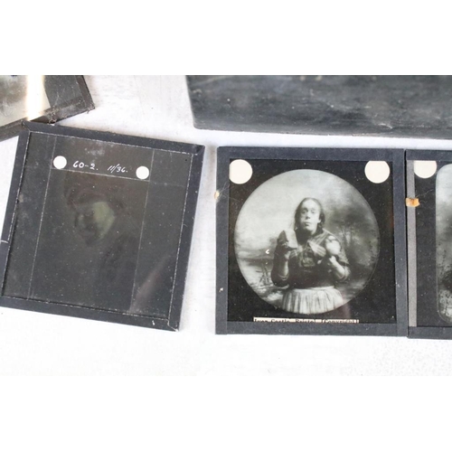 601 - A collection of over 100 magic lantern slides contained within three wooden boxes, mainly people to ... 