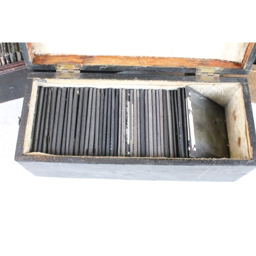 601 - A collection of over 100 magic lantern slides contained within three wooden boxes, mainly people to ... 