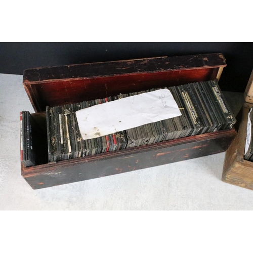 601 - A collection of over 100 magic lantern slides contained within three wooden boxes, mainly people to ... 