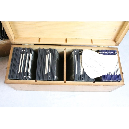 602 - A collection of over 100 glass magic lantern slides contained within three wooden, mainly people to ... 