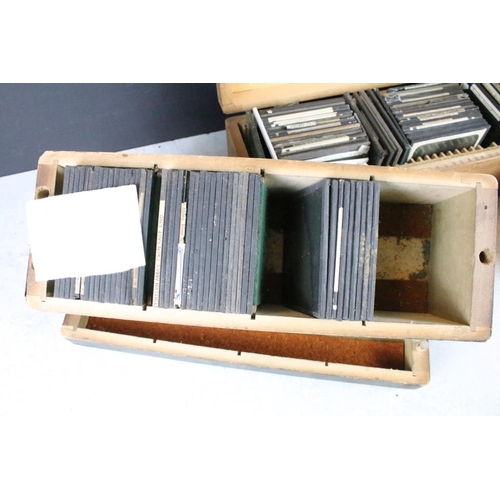 602 - A collection of over 100 glass magic lantern slides contained within three wooden, mainly people to ... 