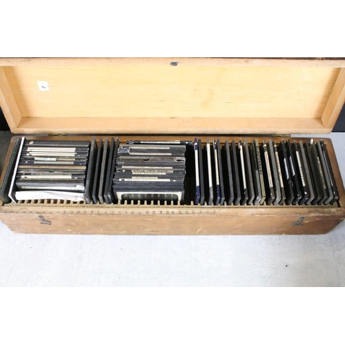 602 - A collection of over 100 glass magic lantern slides contained within three wooden, mainly people to ... 