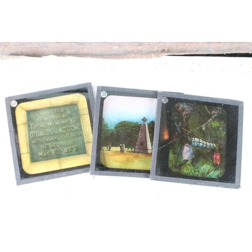 603 - A collection of over 100 glass magic lantern slides contained within three wooden boxes, mainly reli... 