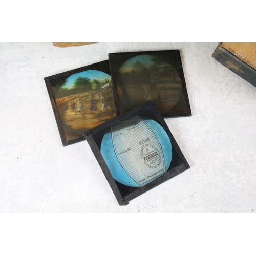 604 - A collection of over 100 glass magic lantern slides contained within three wooden boxes to include W... 