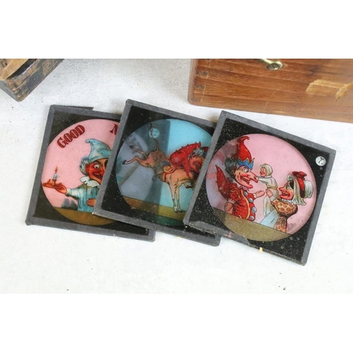 604 - A collection of over 100 glass magic lantern slides contained within three wooden boxes to include W... 