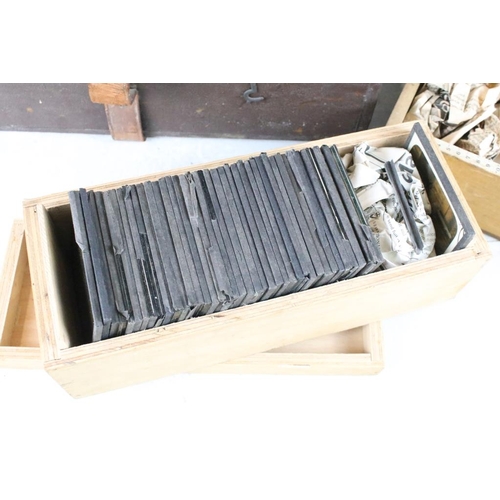 605 - A collection of over 100 glass magic lantern slides contained within three wooden boxes to include A... 