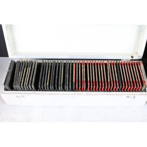 623 - A collection of approx 100 x glass magic lantern slides contained within three wooden cases to inclu... 