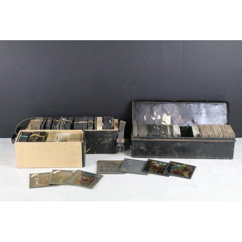 624 - A collection of approx 100 x glass magic lantern slides contained within three wooden cases to inclu... 