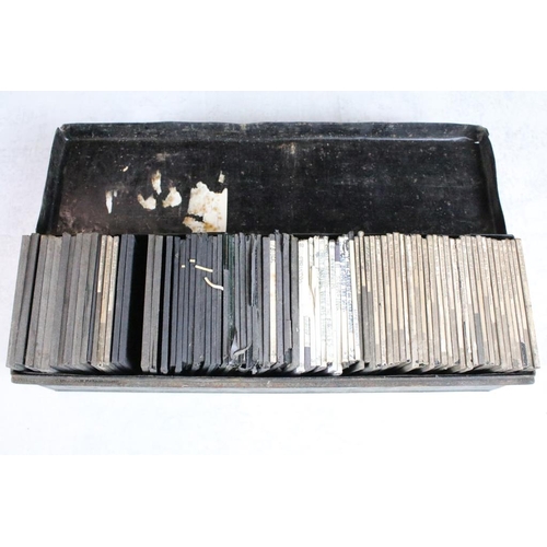 624 - A collection of approx 100 x glass magic lantern slides contained within three wooden cases to inclu... 