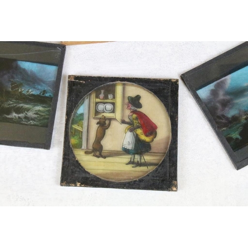 625 - A collection of approx 100 x glass magic lantern slides contained within three wooden cases to inclu... 