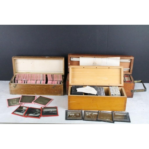 626 - A collection of over 100 x glass magic lantern slides contained within three wooden cases to include... 