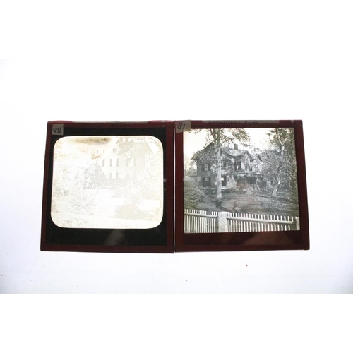 626 - A collection of over 100 x glass magic lantern slides contained within three wooden cases to include... 