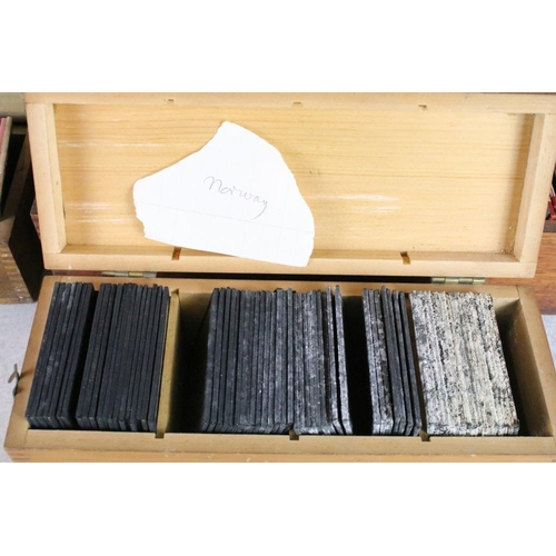 626 - A collection of over 100 x glass magic lantern slides contained within three wooden cases to include... 