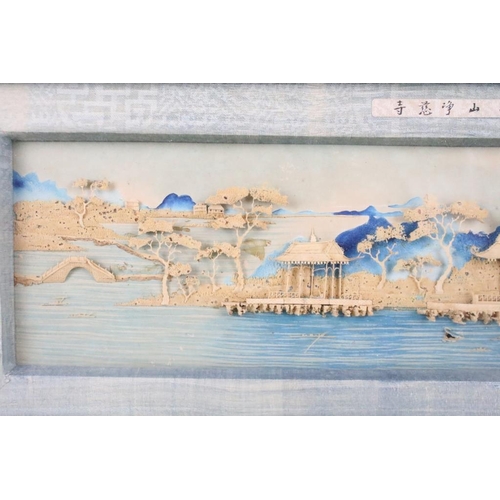 438 - Early 20th century, Chinese landscape scene with pagoda, moulded in relief against a backdrop painte... 