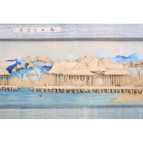 438 - Early 20th century, Chinese landscape scene with pagoda, moulded in relief against a backdrop painte... 