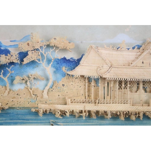 438 - Early 20th century, Chinese landscape scene with pagoda, moulded in relief against a backdrop painte... 