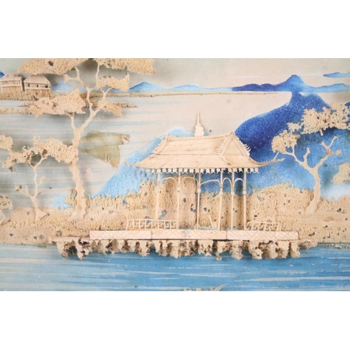 438 - Early 20th century, Chinese landscape scene with pagoda, moulded in relief against a backdrop painte... 