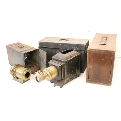 633 - A collection of three magic lantern projectors contained within storage cases. (A/F).