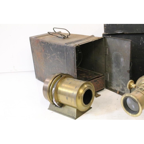 633 - A collection of three magic lantern projectors contained within storage cases. (A/F).