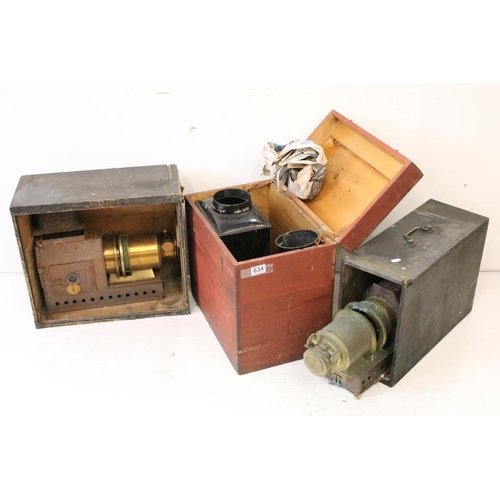 634 - A collection of three magic lantern projectors contained within storage cases to include a 'The Prae... 