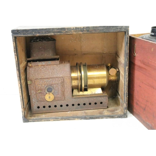 634 - A collection of three magic lantern projectors contained within storage cases to include a 'The Prae... 