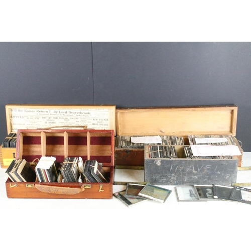 635 - A collection of over 100 glass magic lantern slides contained within four wooden cases to include Ro... 