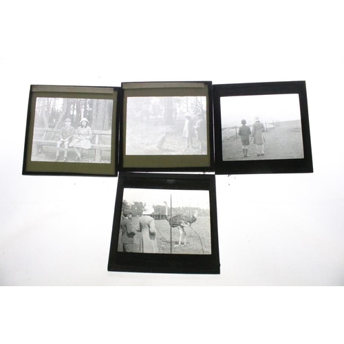 636 - A collection of over 100 mixed glass magic lantern slides contained within four wooden cases to incl... 