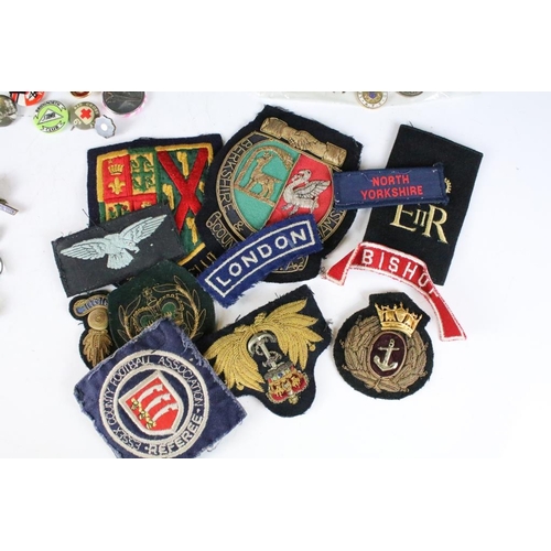 198 - A collection of mixed button, enamel and cloth badges to include music, military, association and cl... 