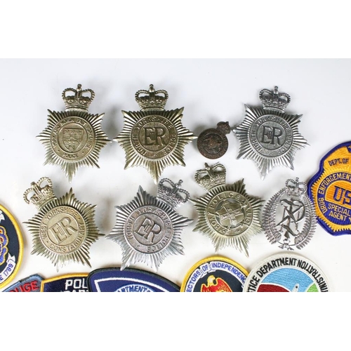 199 - A collection of mixed Police badges to include helmet badges from various British constabilaries and... 