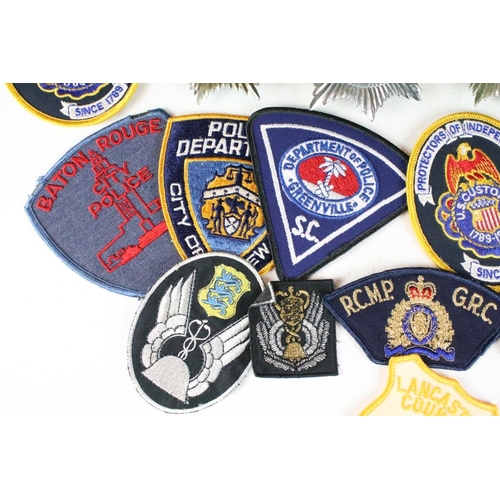 199 - A collection of mixed Police badges to include helmet badges from various British constabilaries and... 