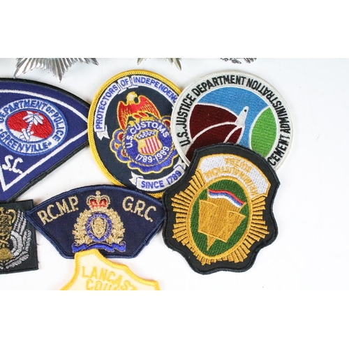 199 - A collection of mixed Police badges to include helmet badges from various British constabilaries and... 