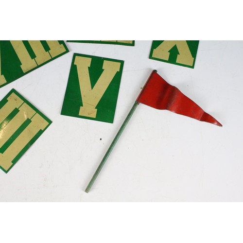 200 - A collection of tin plate Roman numeral markers together with a red tin plate flag.