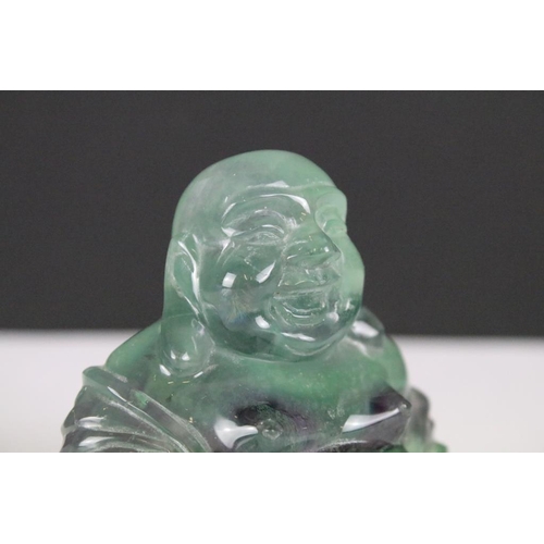 201 - A hand craved fluorite ornamental buddha, stands approx 7cm in height.