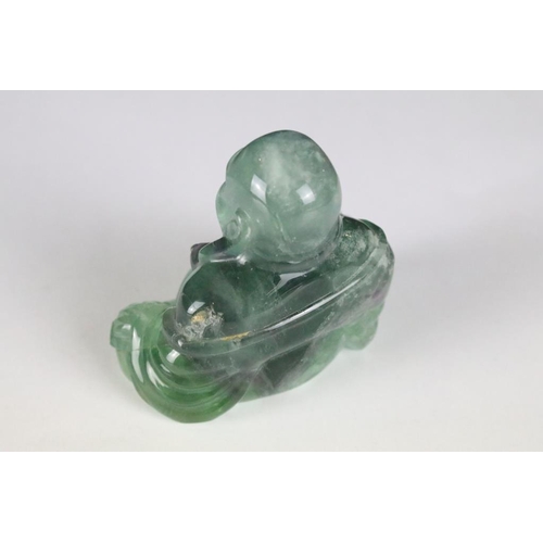 201 - A hand craved fluorite ornamental buddha, stands approx 7cm in height.