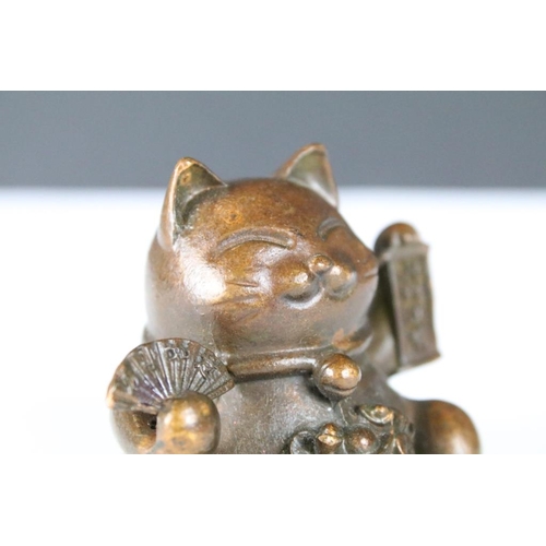 203 - An ornamental Japanese bronze 招き猫 / maneki-neko (waving / beckoning) lucky cat talisman.