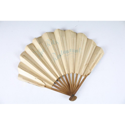 208 - An antique French paper fan with figural decoration on wooden frame, marked the Ritz Restaurant to v... 