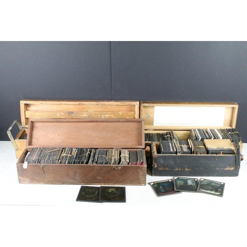 637 - A collection of over 100 glass magic lantern slides contained within four wooden cases to include Re... 