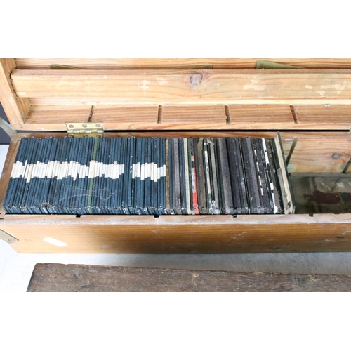 637 - A collection of over 100 glass magic lantern slides contained within four wooden cases to include Re... 