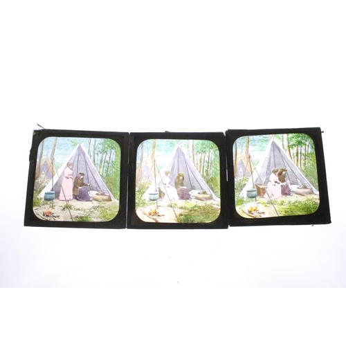 642 - A collection of over 100 glass magic lantern slides contained within three wooden cases to include p... 