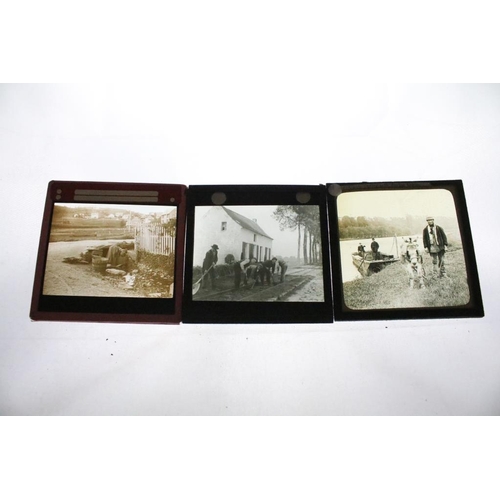 644 - A collection of over 50 glass magic lantern slides contained within a wooden case to include Leisure... 