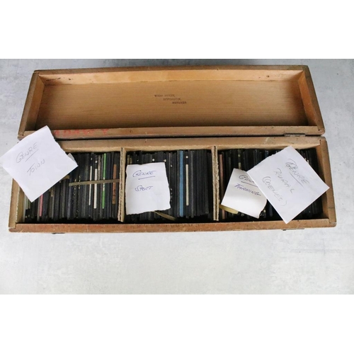 644 - A collection of over 50 glass magic lantern slides contained within a wooden case to include Leisure... 