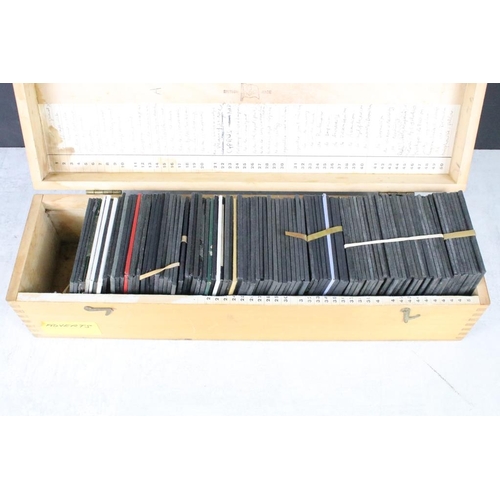 645 - A collection of approx 50 glass magic lantern slides contained within a wooden case to include adver... 