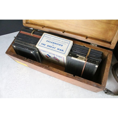 646 - A collection of over 100 glass magic lantern slides contained within three wooden cases to include T... 