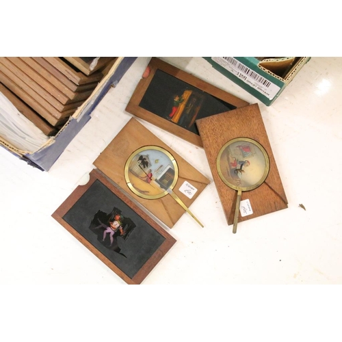 650 - A large collection of wooden framed coloured magic lantern slides to include lever action examples, ... 