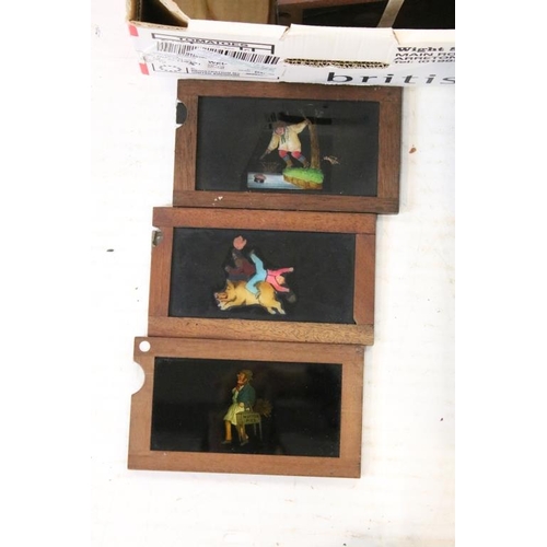 650 - A large collection of wooden framed coloured magic lantern slides to include lever action examples, ... 