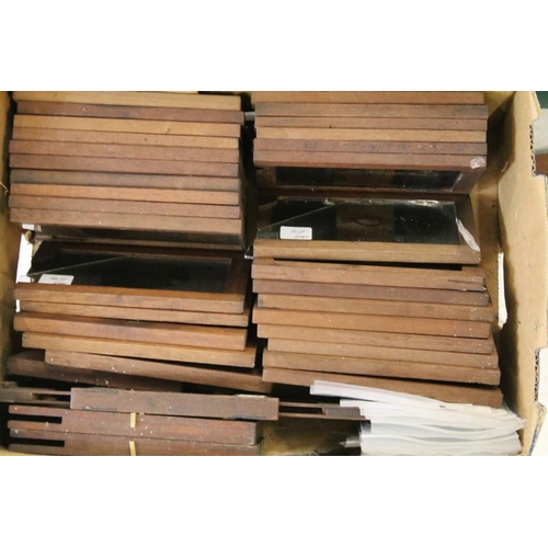 650 - A large collection of wooden framed coloured magic lantern slides to include lever action examples, ... 