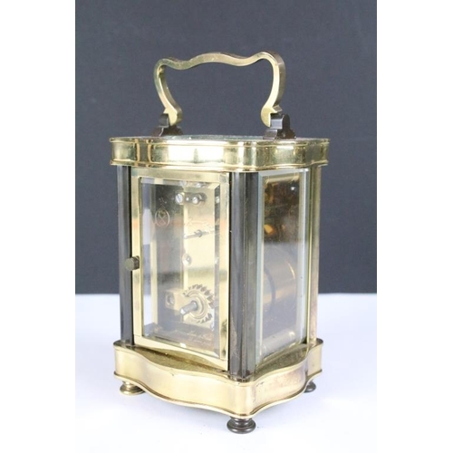 235 - A French made gilt brass cased carriage clock with bevelled glass panels, complete with key.