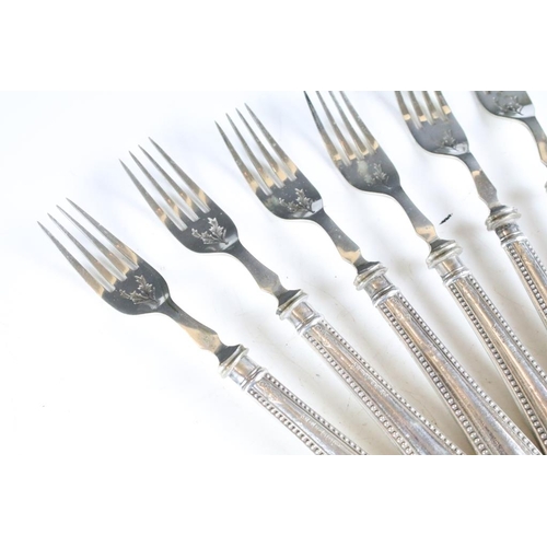 257 - A set of six knives and forks with hallmarked sterling silver handles.