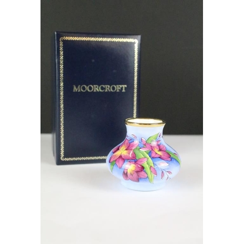 258 - Two miniature Moorcroft vases with enamel decoration, both within fitted display boxes.